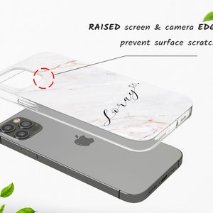 May include: A clear phone case with a white marble design and the word "Love" written in black script. The case has raised edges to protect the screen and camera from scratches.