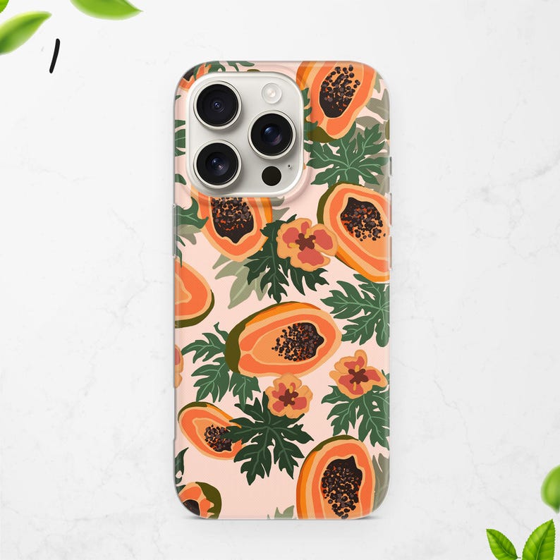 May include: A phone case featuring a repeating pattern of orange papaya fruit slices, flowers, and green leaves on a light pink background. The case has a glossy finish and a camera cutout.