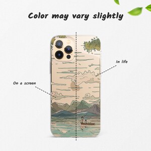May include: A clear phone case with a Japanese-inspired design featuring a mountain landscape, a lake, and two figures in a boat. The text "In life" is written on the right side of the case.
