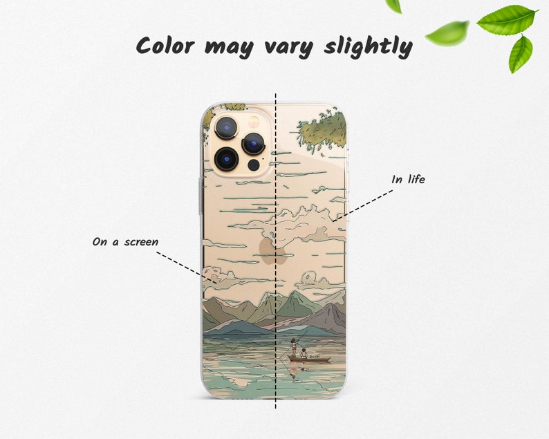 May include: A clear phone case with a Japanese-inspired design featuring a mountain landscape, a lake, and two figures in a boat. The text "In life" is written on the right side of the case.
