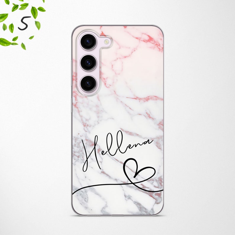 May include: A white and pink marble phone case with a black outline of a heart and the name "Helena" written in cursive.