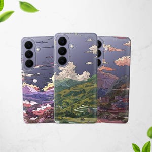 May include: Three phone cases with landscape designs. The cases depict mountains, clouds, and a full moon. The colour scheme includes shades of purple, green, and orange. Each case has a camera module with three lenses.