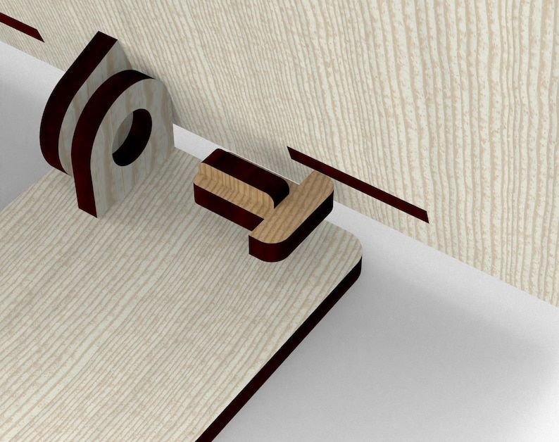May include: A close-up of a wooden cabinet door with a mortise and tenon joint. The cabinet door is light-colored with a wood grain pattern. The joint is dark brown and appears to be a decorative element.