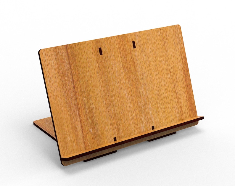 May include: A wooden book stand with a light brown finish. The stand is angled with a base and a back panel, featuring a slot for holding books. The wood grain is visible, and the stand appears to be made of layered wood.