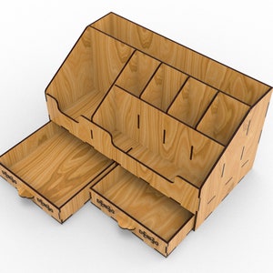 May include: Wooden desk organizer with multiple compartments and a pull-out drawer. The organizer is made of light brown wood with a natural wood grain.