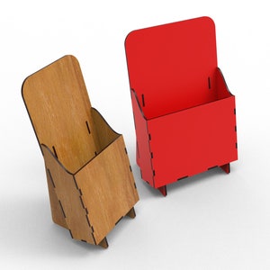 May include: Two wooden brochure holders, one is natural wood and the other is painted red. Both holders have a rectangular shape with a vertical front panel and a horizontal base.