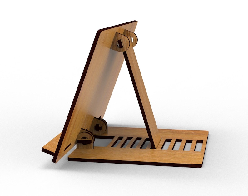 May include: A wooden tablet stand with a light brown finish and dark brown edges. The stand is designed with a base, an angled support, and a back panel, all connected with interlocking joints. The base features several rectangular cutouts.