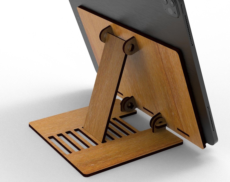 May include: A wooden tablet stand with a natural wood grain finish. The stand is designed with a base, a supporting arm, and a back panel to hold the tablet. The base has several rectangular cutouts. The tablet is black.