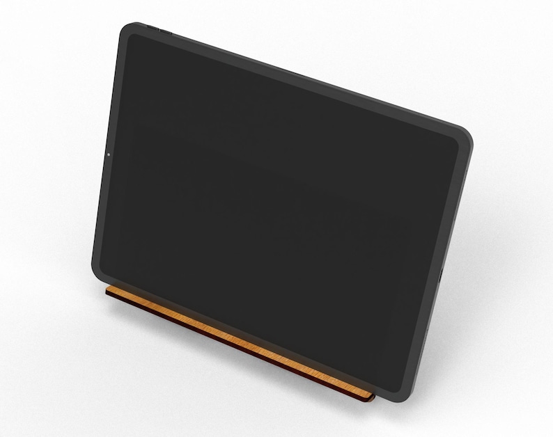 May include: A black tablet is propped up on a wooden stand. The tablet's screen is dark, and the stand is a light brown color. The stand is rectangular and appears to be made of wood.