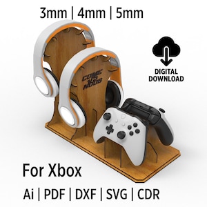 May include: A wooden stand for an Xbox controller and two headsets. The stand is made of wood and has a brown finish. The stand is designed to hold a controller and two headsets. The stand is available in three different thicknesses: 3mm, 4mm, and 5mm. The stand is a digital download and can be printed on a 3D printer.