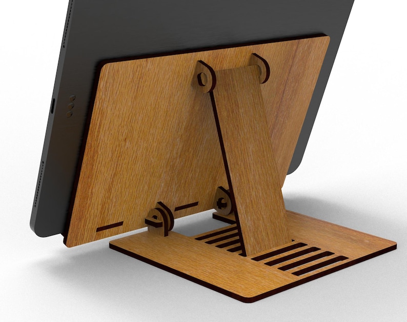 May include: A wooden tablet stand with a natural wood grain finish. The stand features a back support and a base with ventilation slots. The tablet is black and rests against the wooden back.