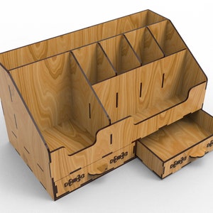 May include: Wooden desk organizer with multiple compartments and two drawers. The organizer is made of light brown wood with a wood grain pattern. The drawers have decorative pulls.