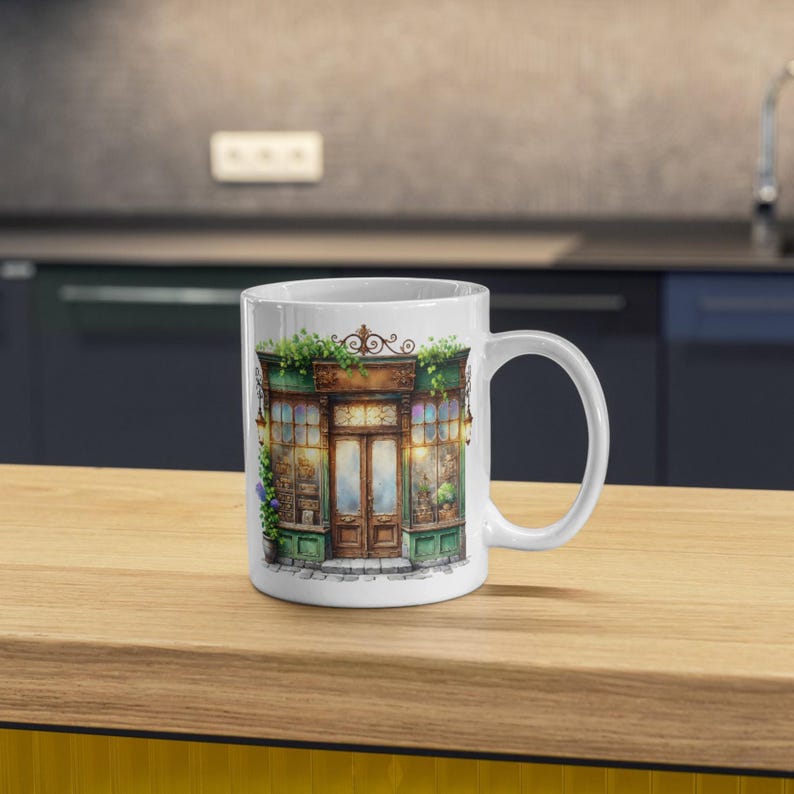 A white ceramic mug featuring a watercolor vintage shop illustration. The elegant storefront print adds a nostalgic touch, perfect for coffee lovers, kitchen decor, or as a thoughtful personalized gift for any occasion.