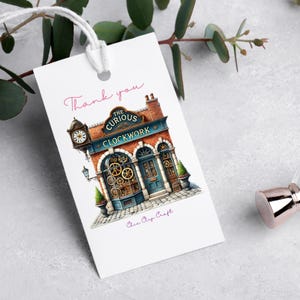 A thank-you gift tag featuring a whimsical clock shop illustration. The vintage storefront design adds an elegant touch to packaging, business branding, or personal gifts. Perfect for handmade crafts, small businesses, and events.