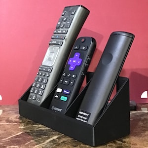 May include: A white ceramic mug with a black handle and the text "But First, Coffee" in a handwritten style. The mug is on a white surface. The mug is likely for hot beverages.