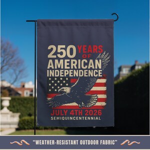 America 250 independence garden flag with eagle and est 1776 design hanging on outdoor stand