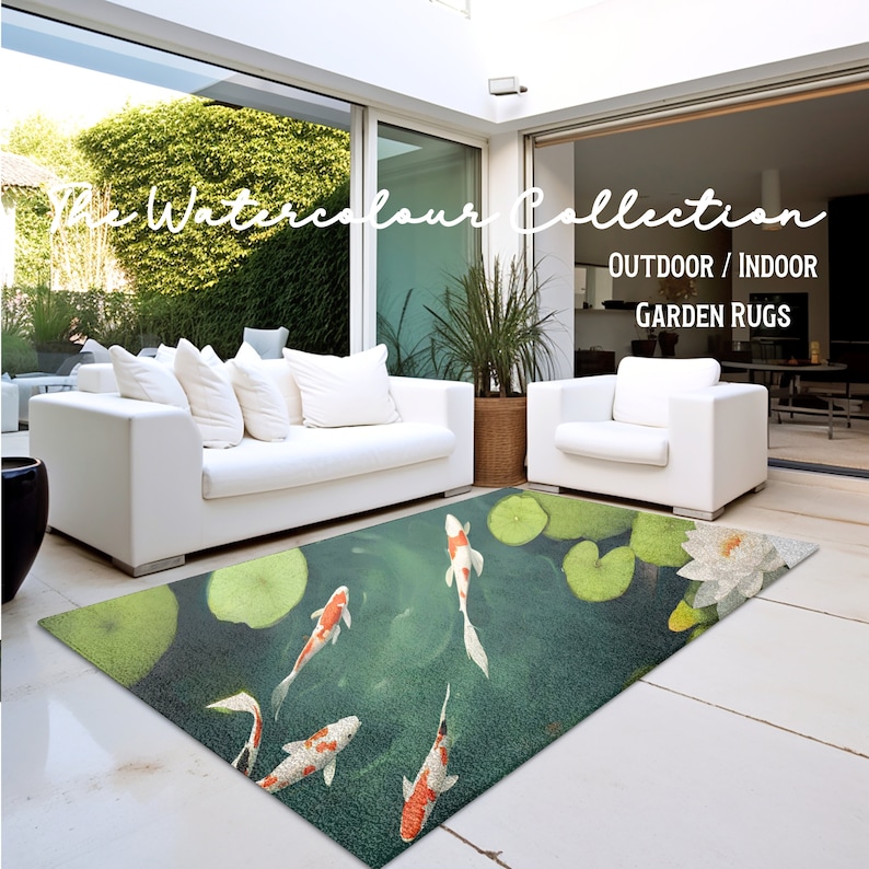 May include: A green and blue rug with a watercolor design of koi fish swimming in a pond with lily pads. The rug is labeled "The Watercolor Collection Outdoor/Indoor Garden Rugs".