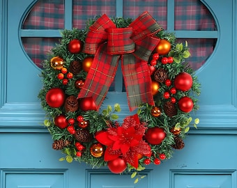May include: A Christmas wreath with a red plaid bow, red and gold ornaments, pine cones, and red berries. The wreath is hanging on a blue door.