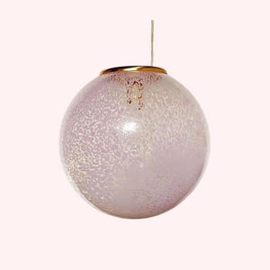 May include: A white, textured glass globe pendant light with a gold rim.