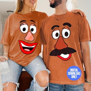 May include: Two people wearing matching orange t-shirts with cartoon potato head faces. The shirts have large eyes, noses, and mouths. The image includes the text "DIGITAL DOWNLOAD ONLY" in a blue circle.