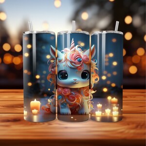 May include: Three tall, cylindrical tumblers with a whimsical unicorn design. The unicorn has large blue eyes, a pink and orange mane, and a horn. The tumblers have a straw and are set against a blurred background with candles.