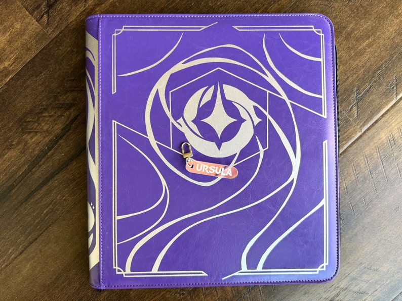 Zipper Pulls to organize Lorcana TCG binders in iridescent color. Ursula with silver clasp is shown
