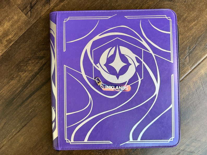 Zipper Pulls to organize Lorcana TCG binders in iridescent color. Inklands with silver clasp is shown