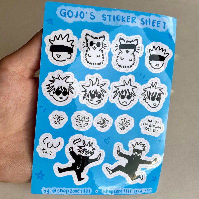 May include: A sticker sheet featuring various illustrations of a character with black hair and sunglasses. The sheet includes a variety of expressions, including a character with a crown, a character with a flower, and a character with the text "Ha Hai I'm Gonna Kill Ya!" The sheet is on a blue background with white borders.