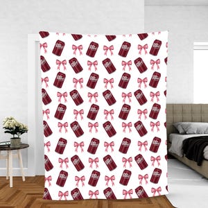 May include: White tapestry with a repeating pattern of Dr. Pepper soda cans and pink bows. The cans are a deep burgundy color with white text. The bows are a soft pink, creating a playful and whimsical design.