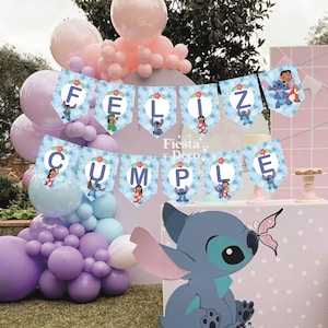 May include: A festive birthday party scene with a banner that reads "Feliz Cumple" in blue pennants, featuring cartoon characters. Balloons in shades of pink, purple, and blue decorate the background. A large cartoon character is in the foreground.