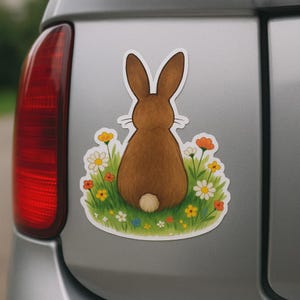 キャンピングカー、ノートパソコン、または車用の、花の草原にいるウサギのステッカー。優しい動物モチーフはガーデニング好きの方やお子様へのプレゼントに。