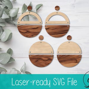 May include: Four pairs of wooden earrings with a two-tone design. The top half is light-colored wood, and the bottom half is a darker, textured wood. Each earring has a small, round stud. The image also includes the text "Laser-ready SVG File".