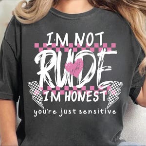 May include: A black t-shirt with a pink and white graphic that says "I'm not rude I'm honest you're just sensitive".
