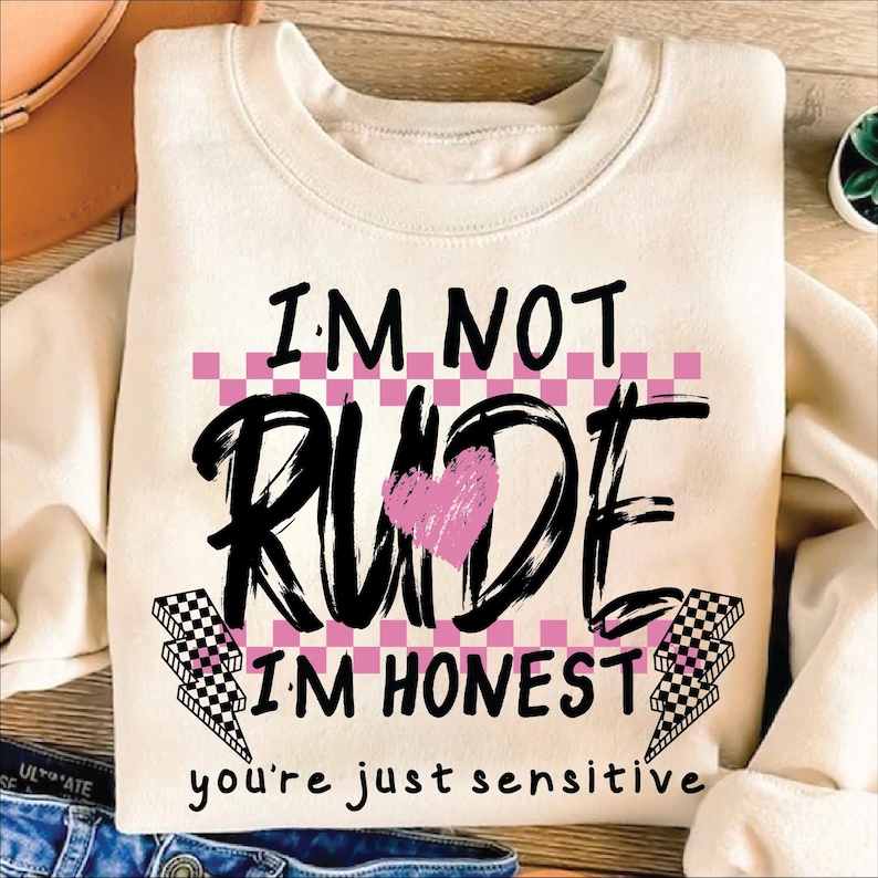 May include: A white sweatshirt with a black and pink graphic that says "I'm not rude I'm honest you're just sensitive".