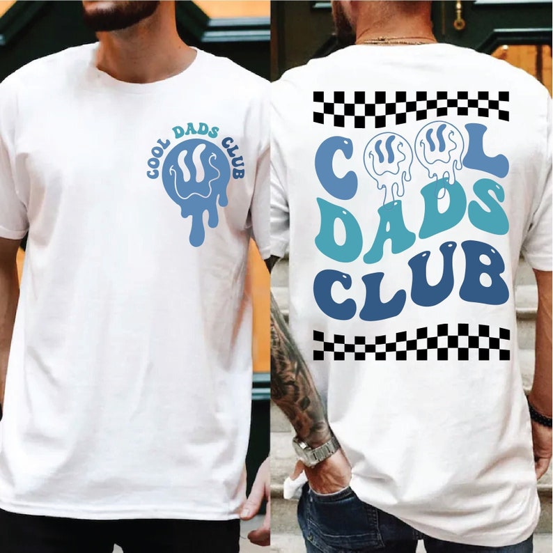 May include: White t-shirt with a blue and white "Cool Dads Club" graphic on the front and back. The front graphic is a dripping smiley face with the text "Cool Dads Club" around it. The back graphic is a larger version of the smiley face with the text "Cool Dads Club" in a wavy font.