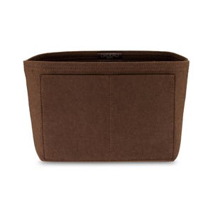 May include: A brown felt bag organizer with a rectangular shape. The organizer has a large open compartment and a front pocket. The word "ORDERLI" is printed on the top edge. The organizer is designed to fit inside a handbag.