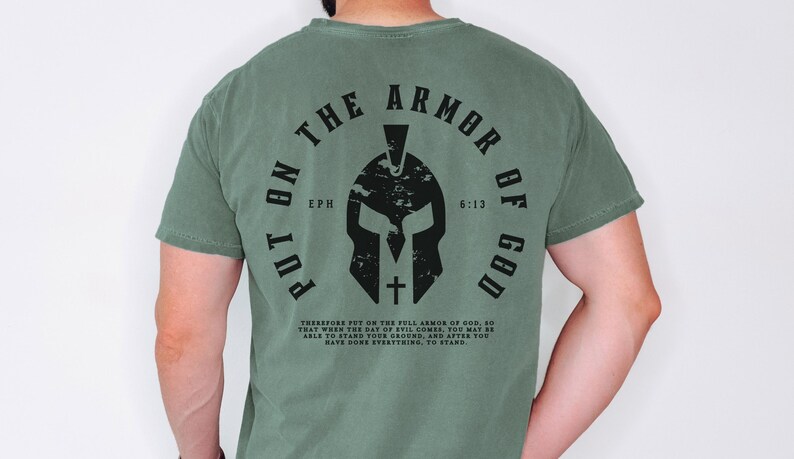 May include: Green t-shirt with a black graphic of a helmet and the text "Put on the Armor of God" with the scripture reference "Eph 6:13".