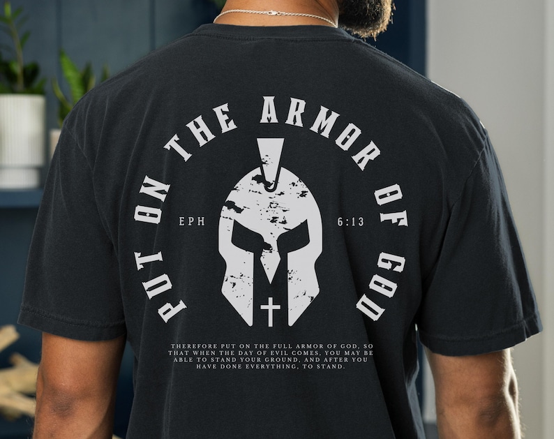 May include: Black t-shirt with a white graphic of a Spartan helmet and the text "Put on the Armor of God" with the scripture reference "Eph 6:13".