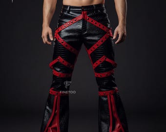 Peut inclure: Pantalon en cuir noir avec des détails rouges et des clous. Le pantalon présente un design à jambes évasées et des sangles rouges avec des rivets. Le cuir a un motif texturé en forme de crocodile. Un vêtement audacieux.