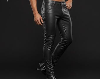 May include: Black trousers with a smooth, leather-like finish, featuring a classic five-pocket design, a front zipper fly, and a button closure. The pants have a slim-fit silhouette and are paired with matching black leather boots.
