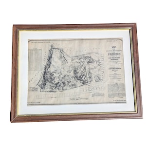 May include: A framed map of the military reservation at the Presidio in San Francisco, California. The map shows the layout of the Presidio, including buildings, roads, and other features. The map is dated 1914.