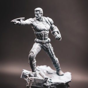 May include: A grey plastic figurine of a superhero standing on a grey plastic base. The superhero is wearing a suit with a belt and is holding a weapon in their right hand.