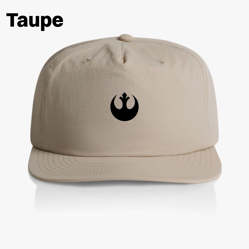 May include: A beige baseball cap with a black Rebel Alliance symbol on the front. The cap is labeled "Taupe".