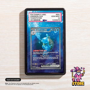 May include: A graded Pokémon card in a black display case. The card features a blue Blastoise EX character with the text "Blastoise EX". The case includes a PSA example label with the text "TCGDOTSTORE". The card is graded as "GEM MINT 10".