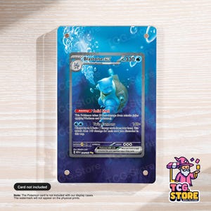 May include: A blue display case featuring a Pokémon card with a Blastoise EX illustration. The card is set against a blue background with bubbles. The TCG Store logo is in the bottom right corner.