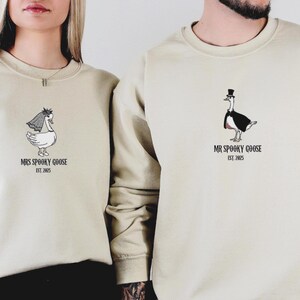 Our "MR & MRS SILLY GOOSE" matching sweatshirts are the perfect way to celebrate love with a side of humor. Featuring hand-drawn, adorable geese (complete with veil and all!) and the cute title “Silly Goose,” these cozy sweaters are sure to bring smiles wherever you go.