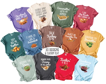 May include: A collection of eleven short-sleeve t-shirts in various colors, each featuring unique Thanksgiving-themed graphics and text such as Go ahead bake my day, Casserollin with my homies, and Talk Turkey to me, with a central label stating 30 DESIGNS & CUSTOM TEXT.