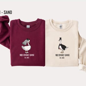 Our "MR & MRS SILLY GOOSE" matching sweatshirts are the perfect way to celebrate love with a side of humor. Featuring hand-drawn, adorable geese (complete with veil and all!) and the cute title “Silly Goose,” these cozy sweaters are sure to bring smiles wherever you go.