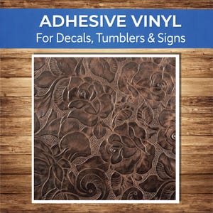 May include: Adhesive vinyl sheet with a brown embossed floral pattern, suitable for decals, tumblers, and signs. The design features detailed roses and leaves. The text "ADHESIVE VINYL For Decals, Tumblers & Signs" is displayed at the top.