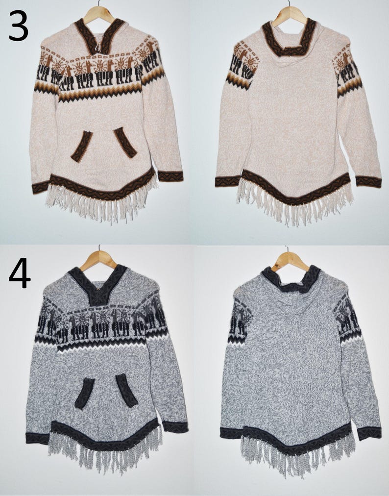 May include: Two hooded ponchos, one beige and one gray, with intricate patterns and fringe detailing. The beige poncho features brown accents and a llama design, while the gray poncho has black accents and a similar pattern. Both are displayed on wooden hangers.